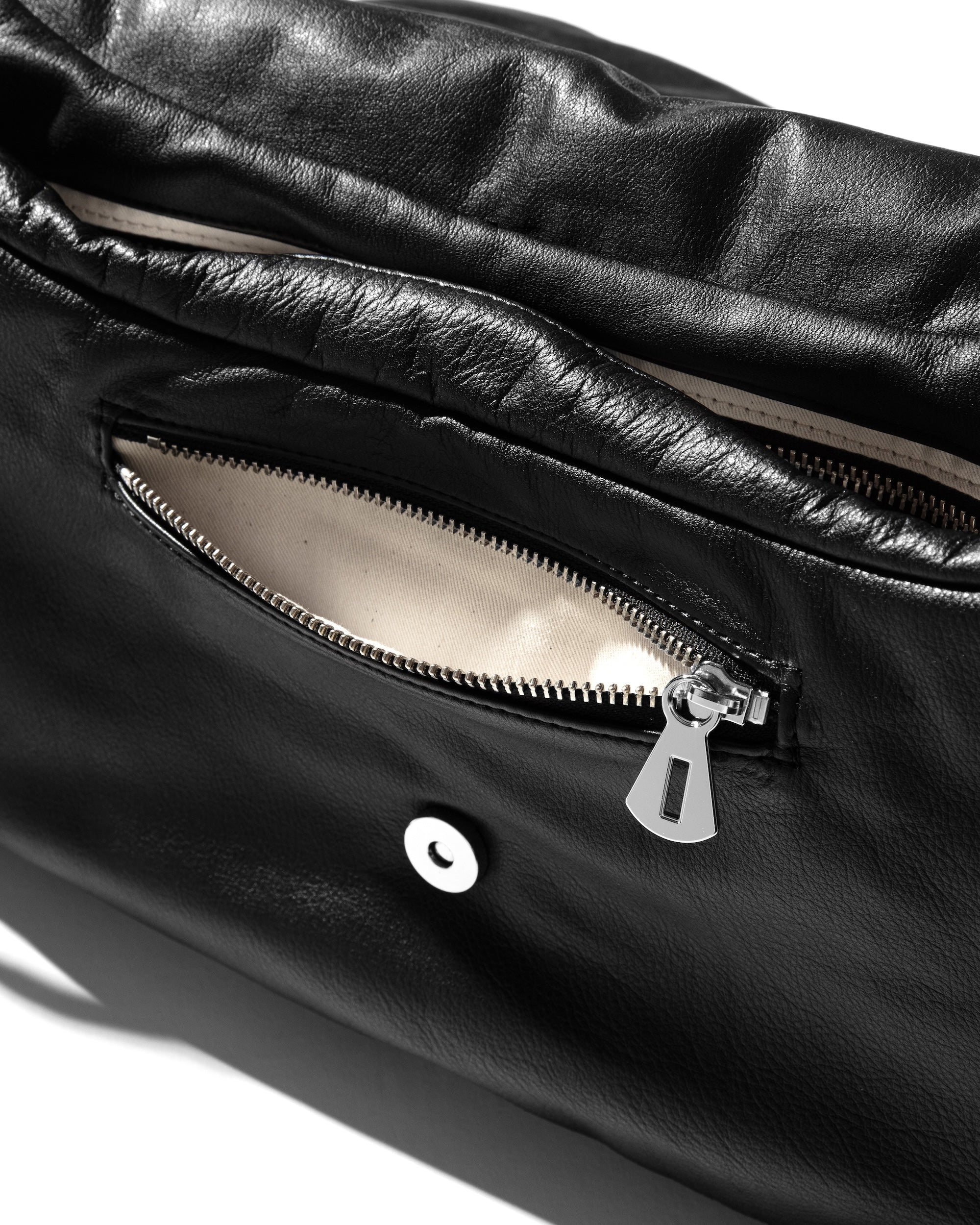 CLESSTE LEATHER PADDED FLAP HOLIDAY BAG