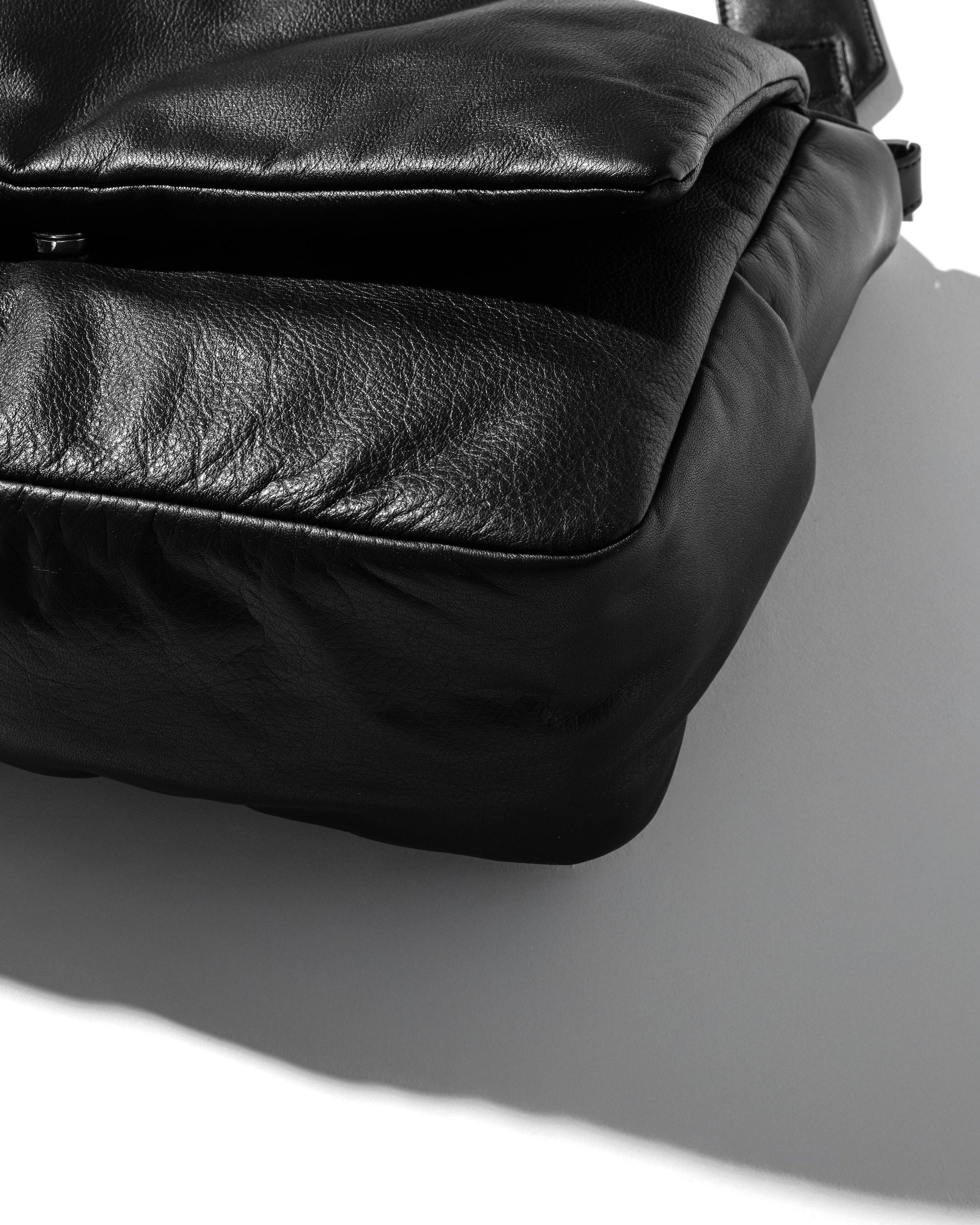 CLESSTE LEATHER PADDED FLAP HOLIDAY BAG