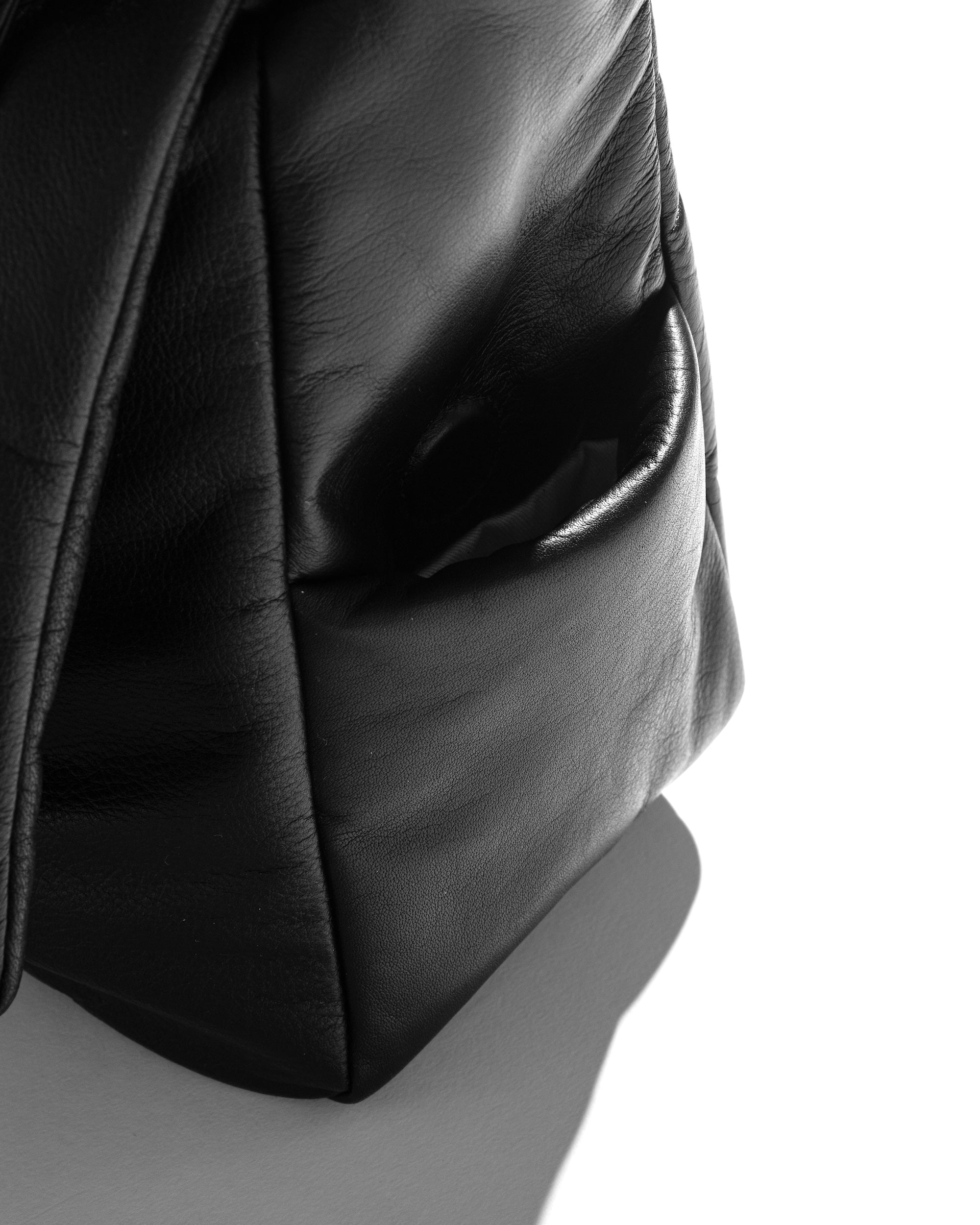 CLESSTE LEATHER PADDED FLAP HOLIDAY BAG